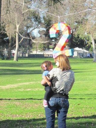 mother and child looking at pinata